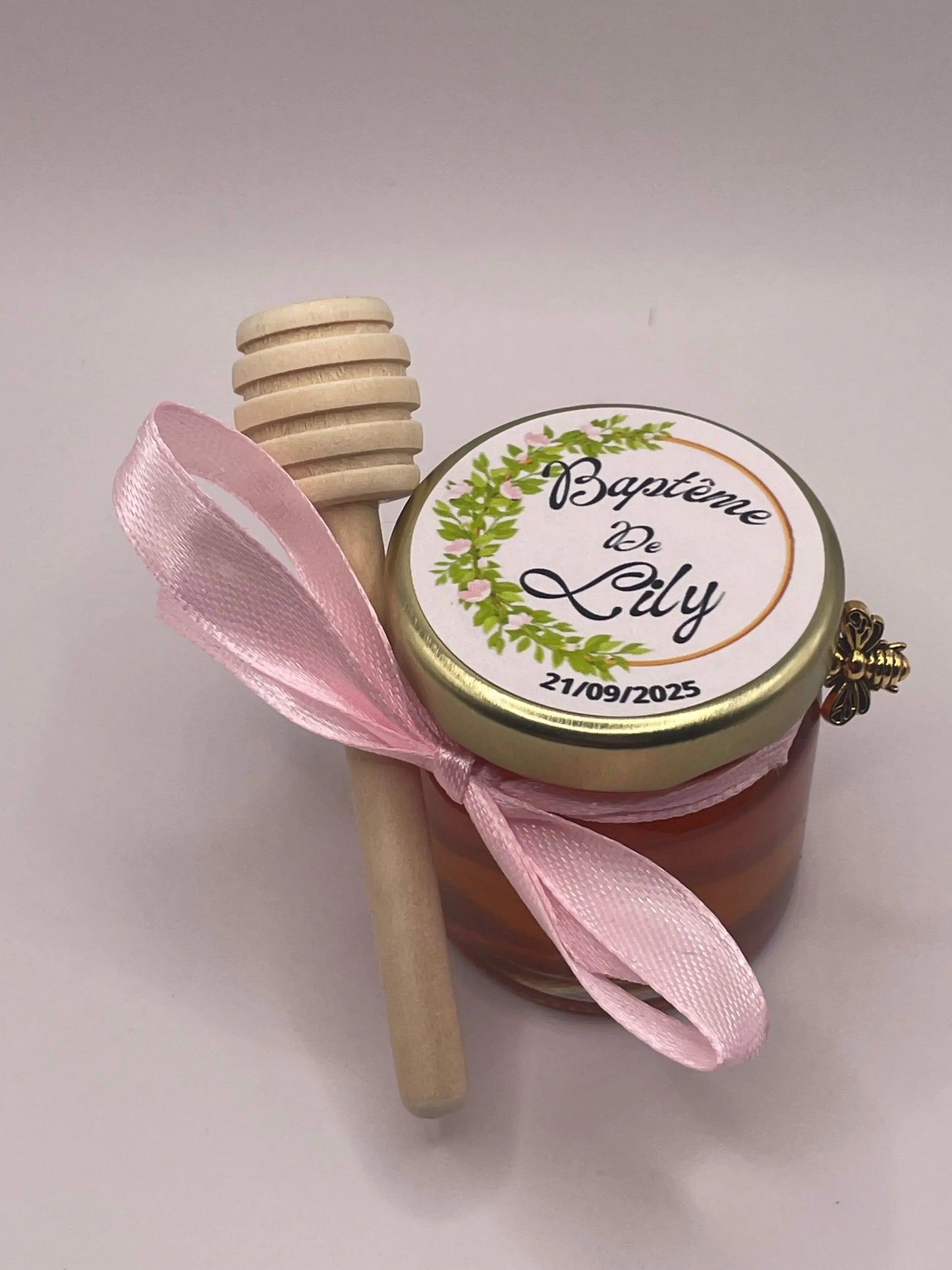 Petit pot de miel personnalisé pour baptême avec étiquette 'Baptême de Lily', ruban rose et cuillère en bois