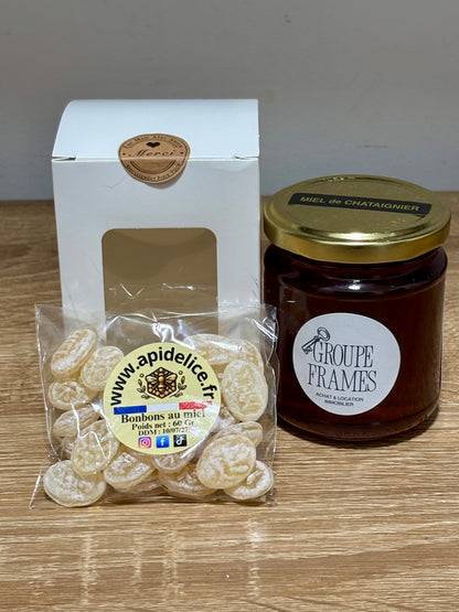 Coffret cadeau miel d'entreprise comprenant un pot de miel de châtaignier personnalisé Groupe Frames, un sachet de bonbons au miel et sa boîte d'emballage.